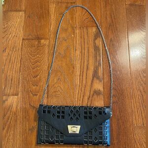 Black faux leather laser cut out fashion purse with gold tone hardware